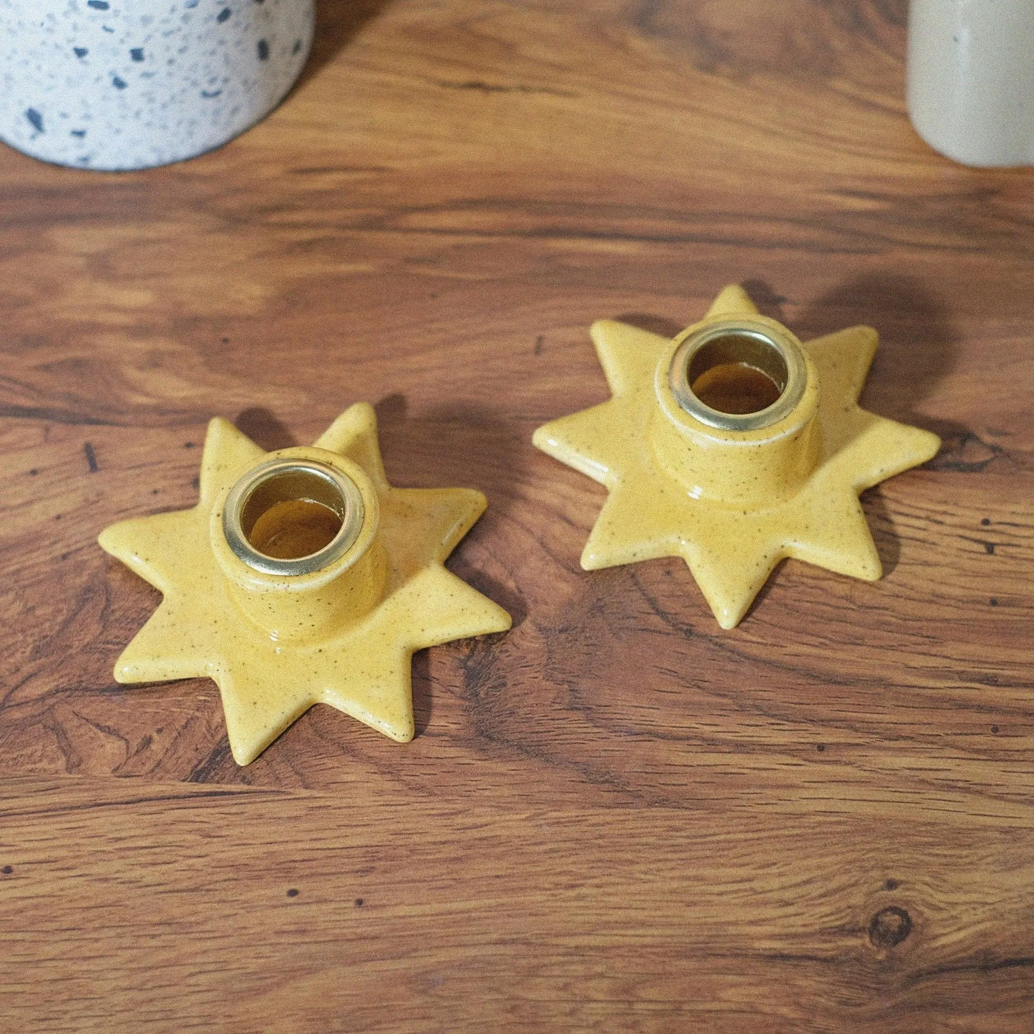 Yellow speckled star shaped candle holder set