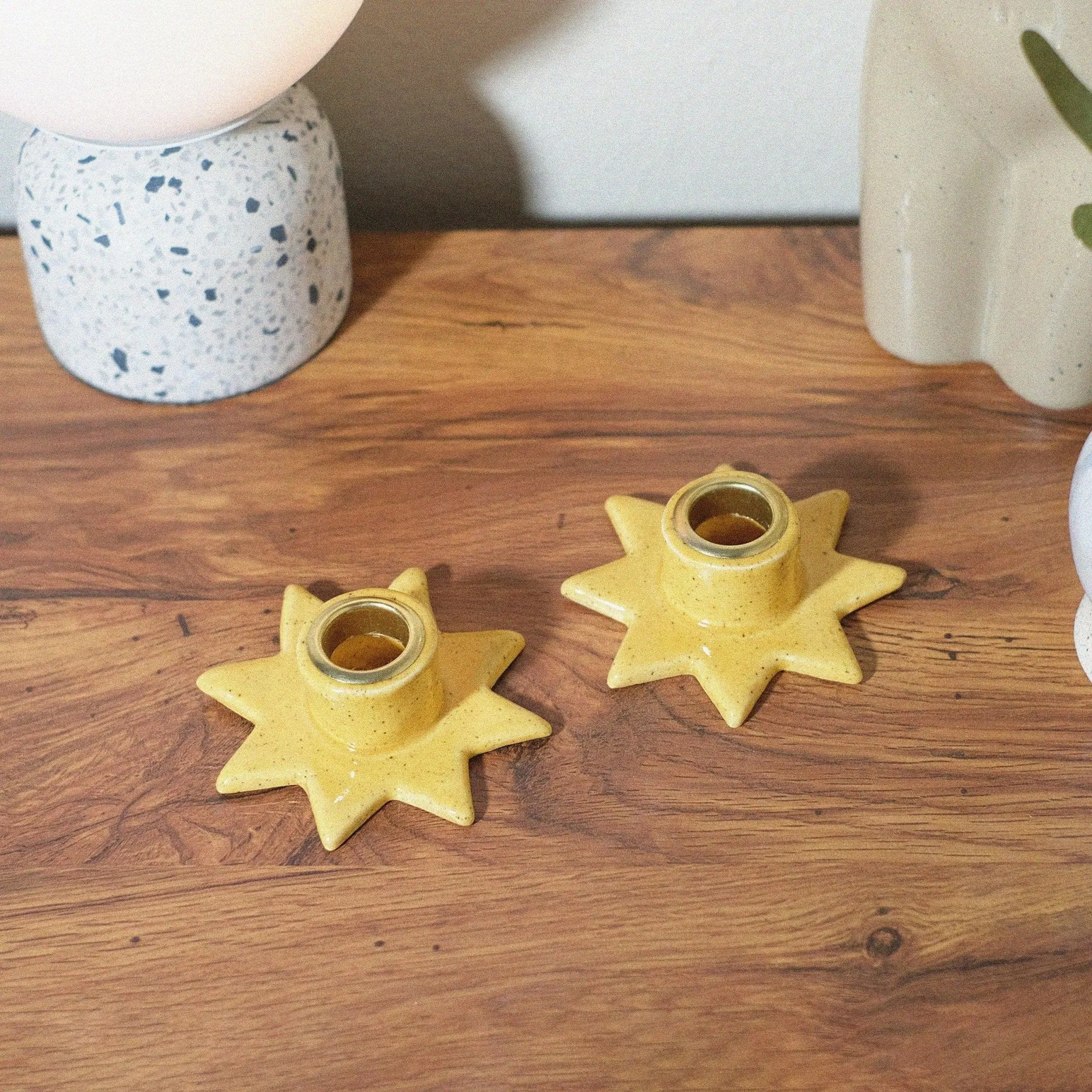 Yellow speckled star shaped candle holder set